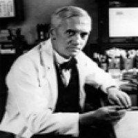 Sir Alexander Fleming observes a culture of mold inhibiting growth of Staphylococcus bacteria in a petri dish